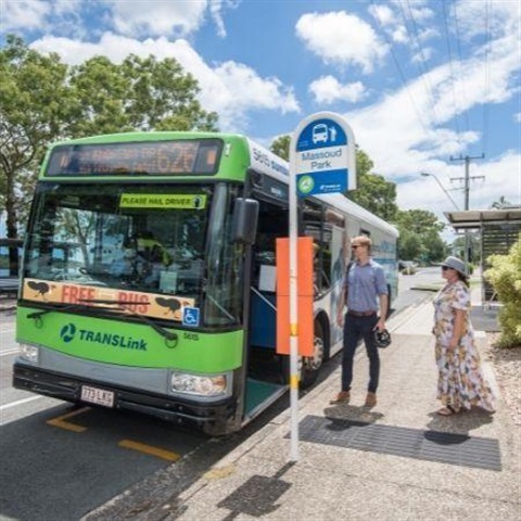Picture of two people about to board a bus