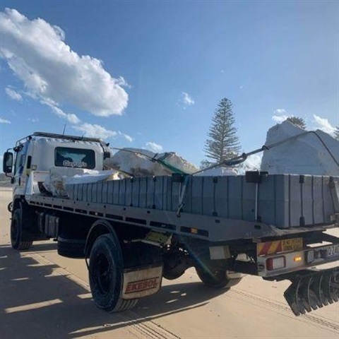 Picture of a truck carrying debris removed from the beach