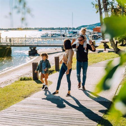 Family walking on a beach sidewalk