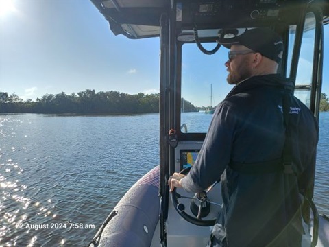 Man on boat water testing