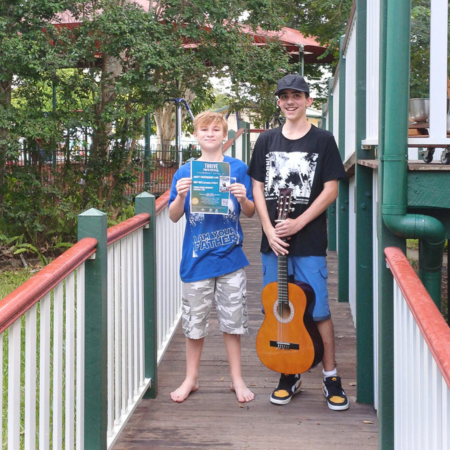 Two kids with a guitar at Thrive Youth festival 
