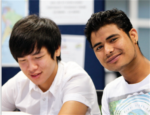 photo of two young men learning in a classroom