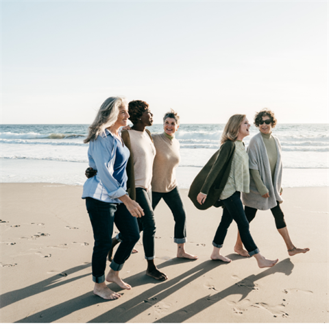 mixed aged women walking on the beach tgether
