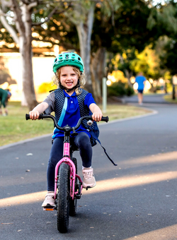 a kid riding a bike to school