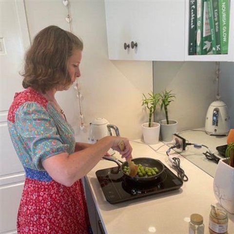 Cooroy resident Ally tests out the portable induction cooktop